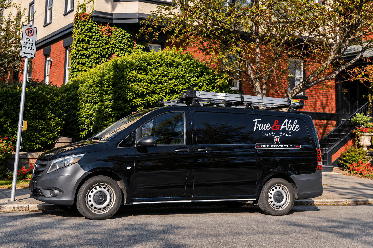 True & Able Fire Protection service van parked outside a residential property in Victoria, BC.